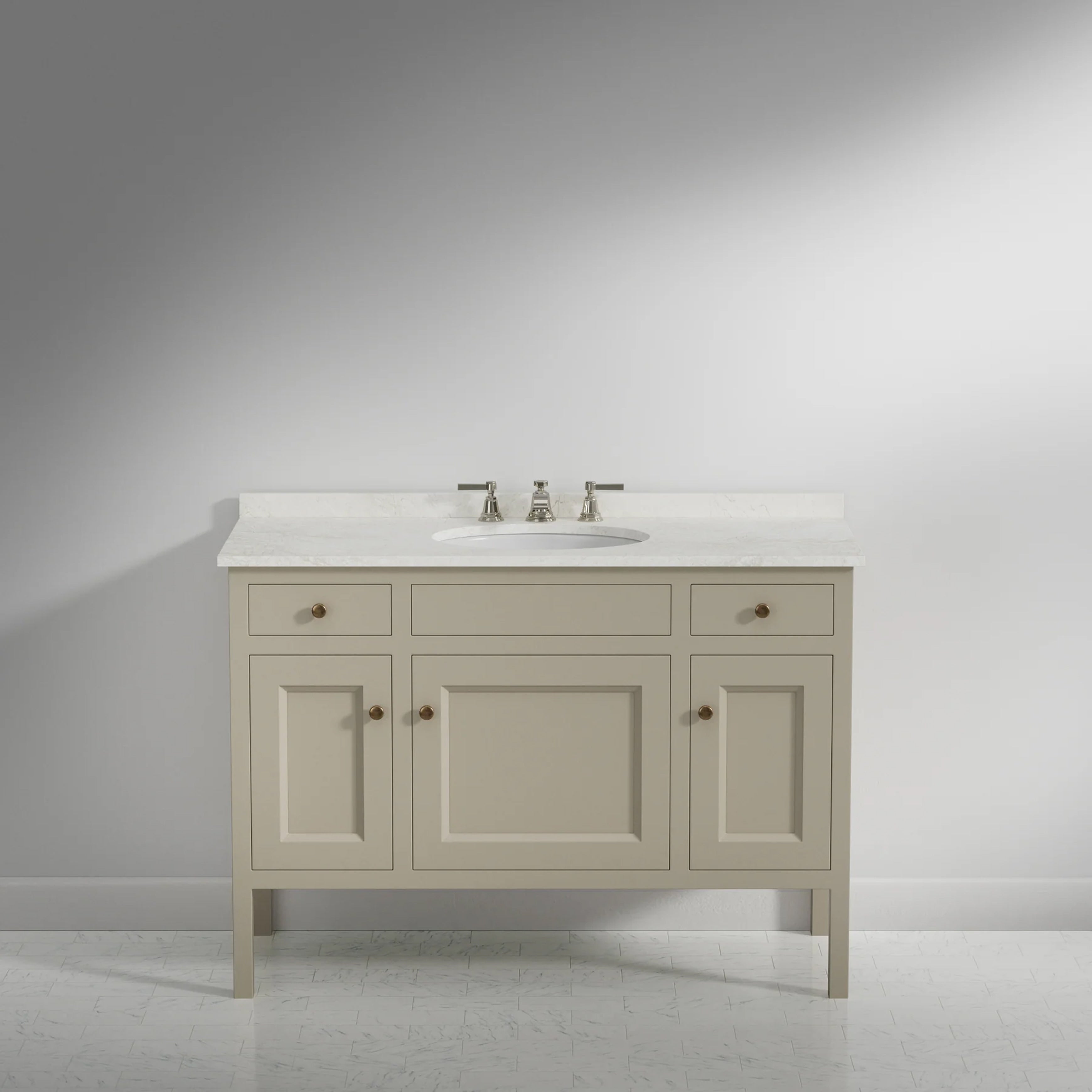 A single bathroom vanity cabinet in a warm off-white/cream finish with a white countertop and integrated sink, shown against a neutral gray studio background.